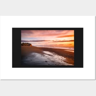 Sunset on a beach Posters and Art